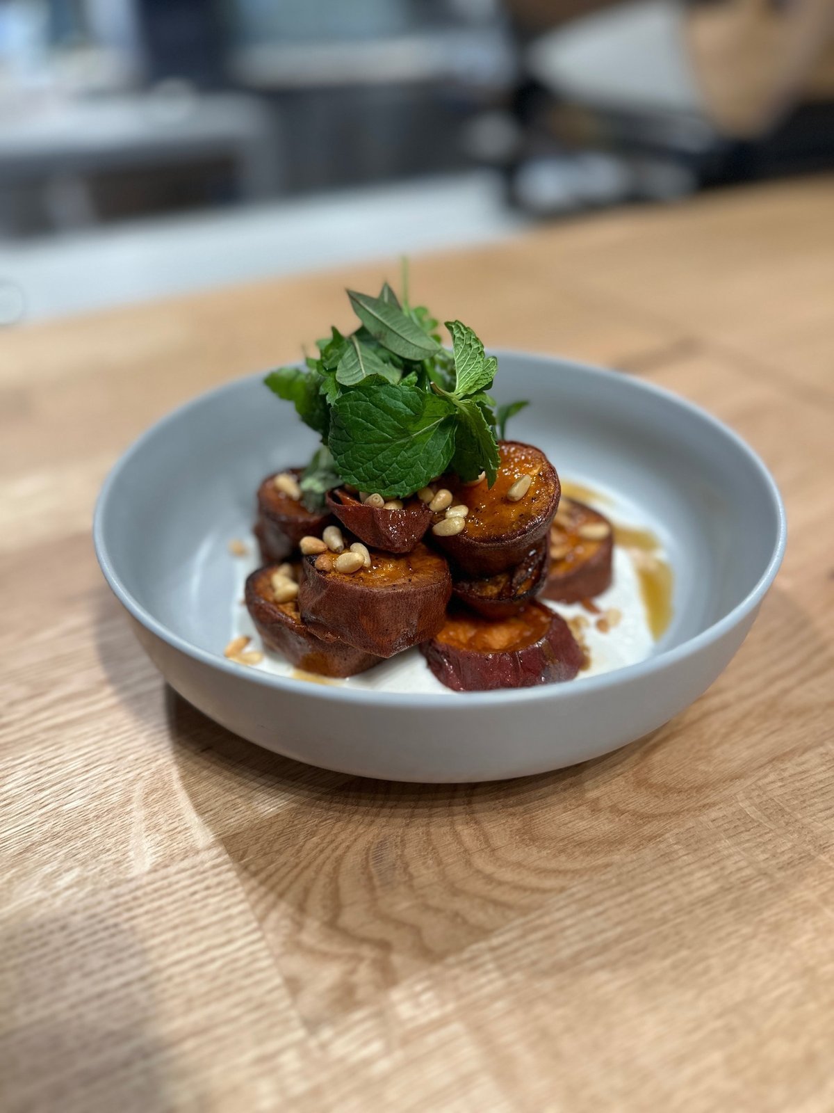 Roasted sweet potato with labneh, mint, and pine nuts